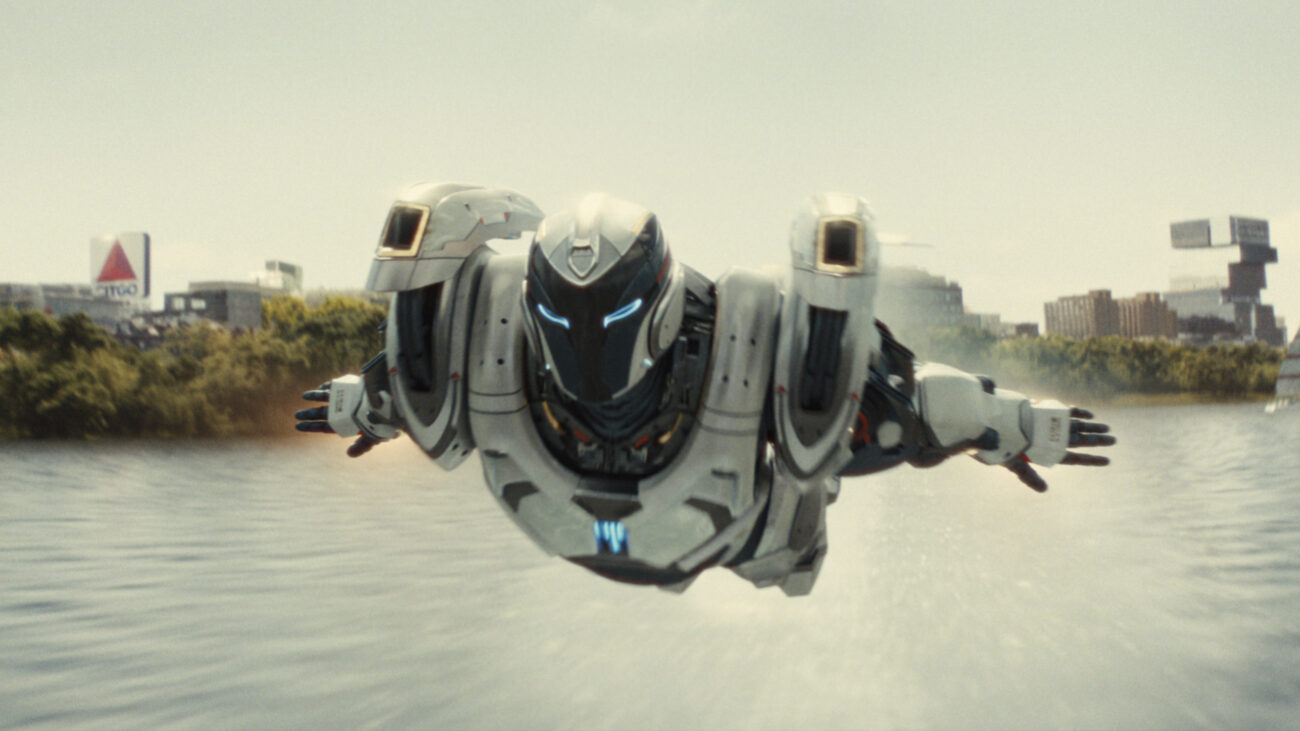Riri Williams (Dominique Thorne) flies across a river in the Ironheart suit in a scene from Marvel's "Ironheart" tv show