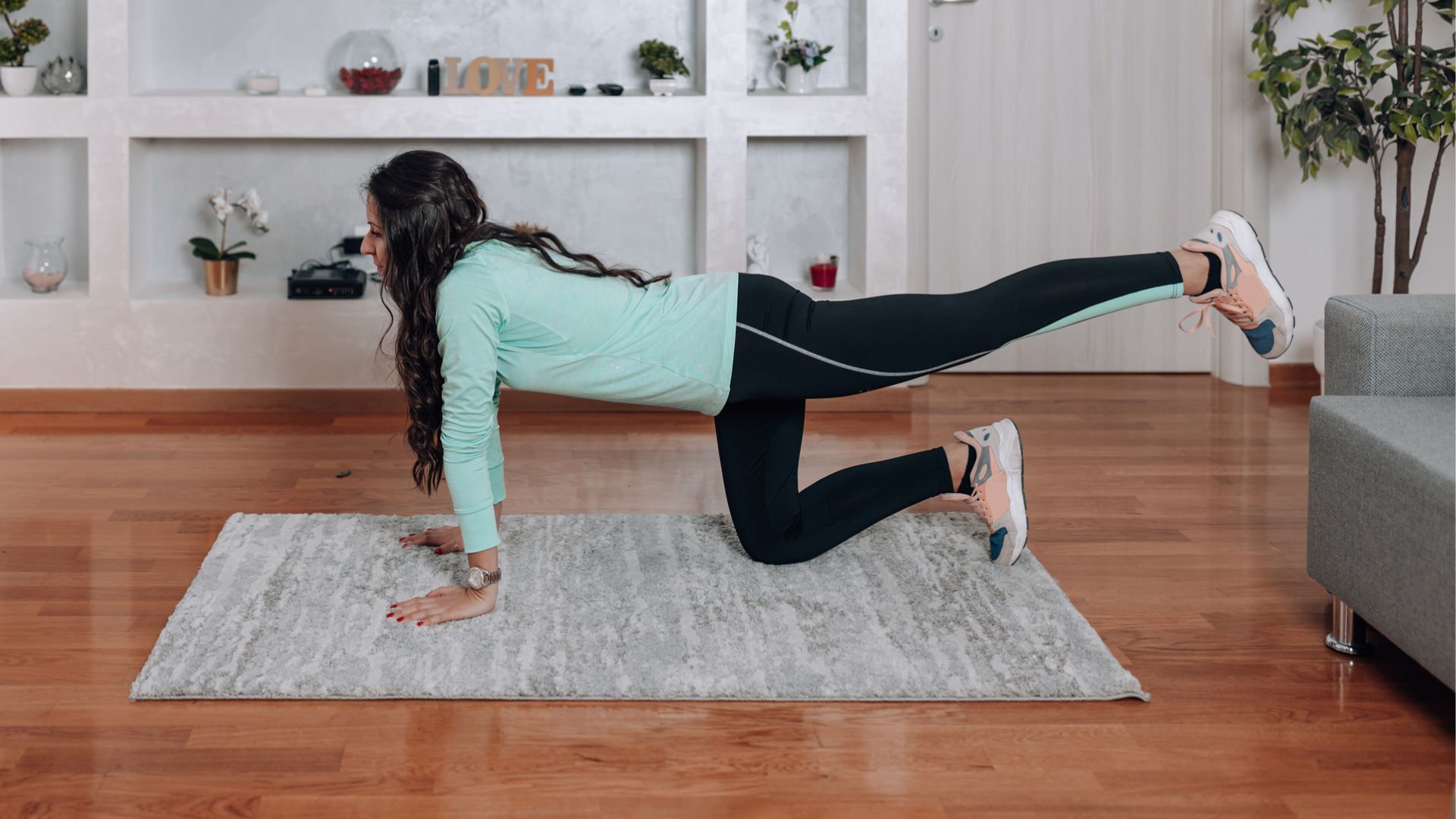 woman at home in glute kick back position on mat