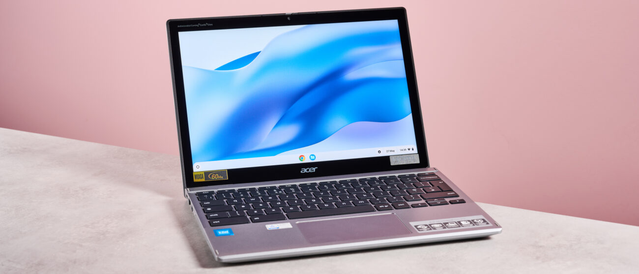 Acer Chromebook Spin 312 open on desk with pink background
