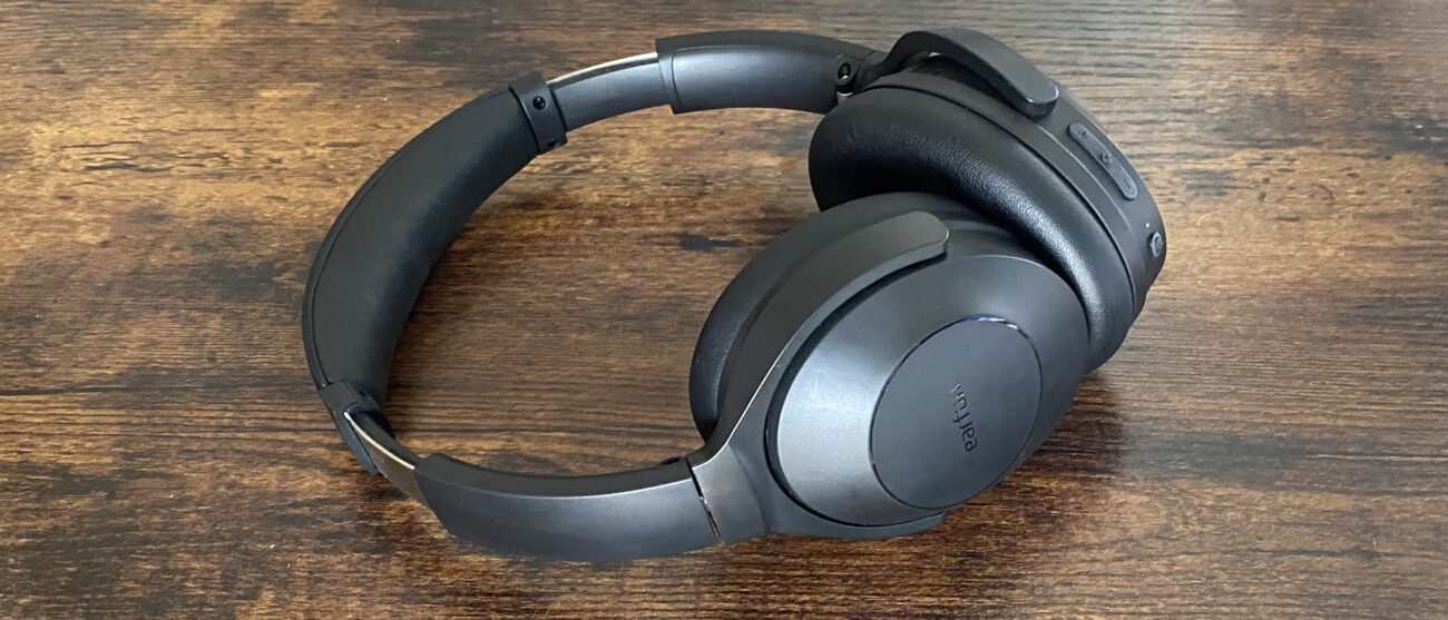 Earfun Wave Life over-ear noise-cancelling headphones on a wooden surface