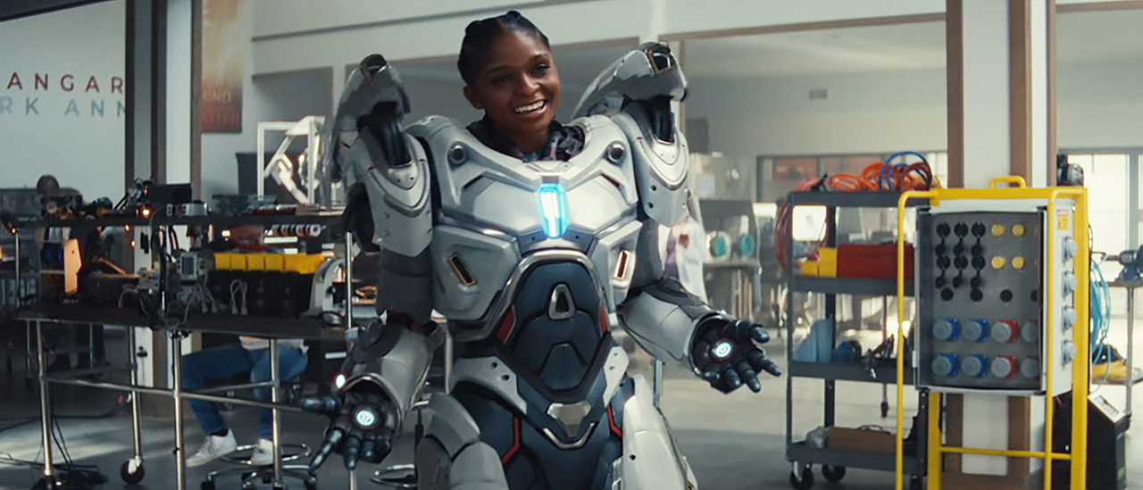 A smiling Riri Williams wearing her white iron armor suit in Ironheart
