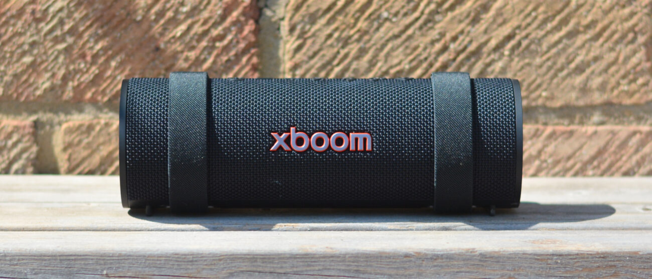 LG xboom Grab Bluetooth speaker in an outdoor setting