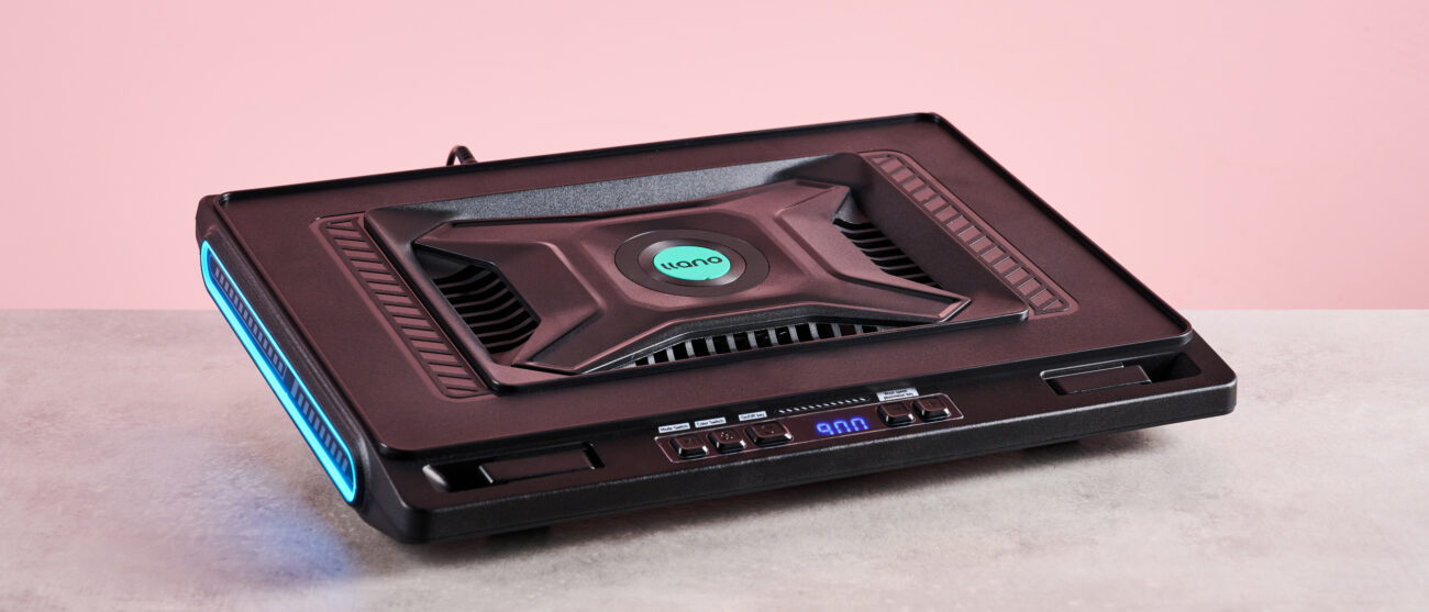 The Llano V10 Gaming Laptop Cooling Pad at a 3/4s angle with RGB lighting in front of a pink background.