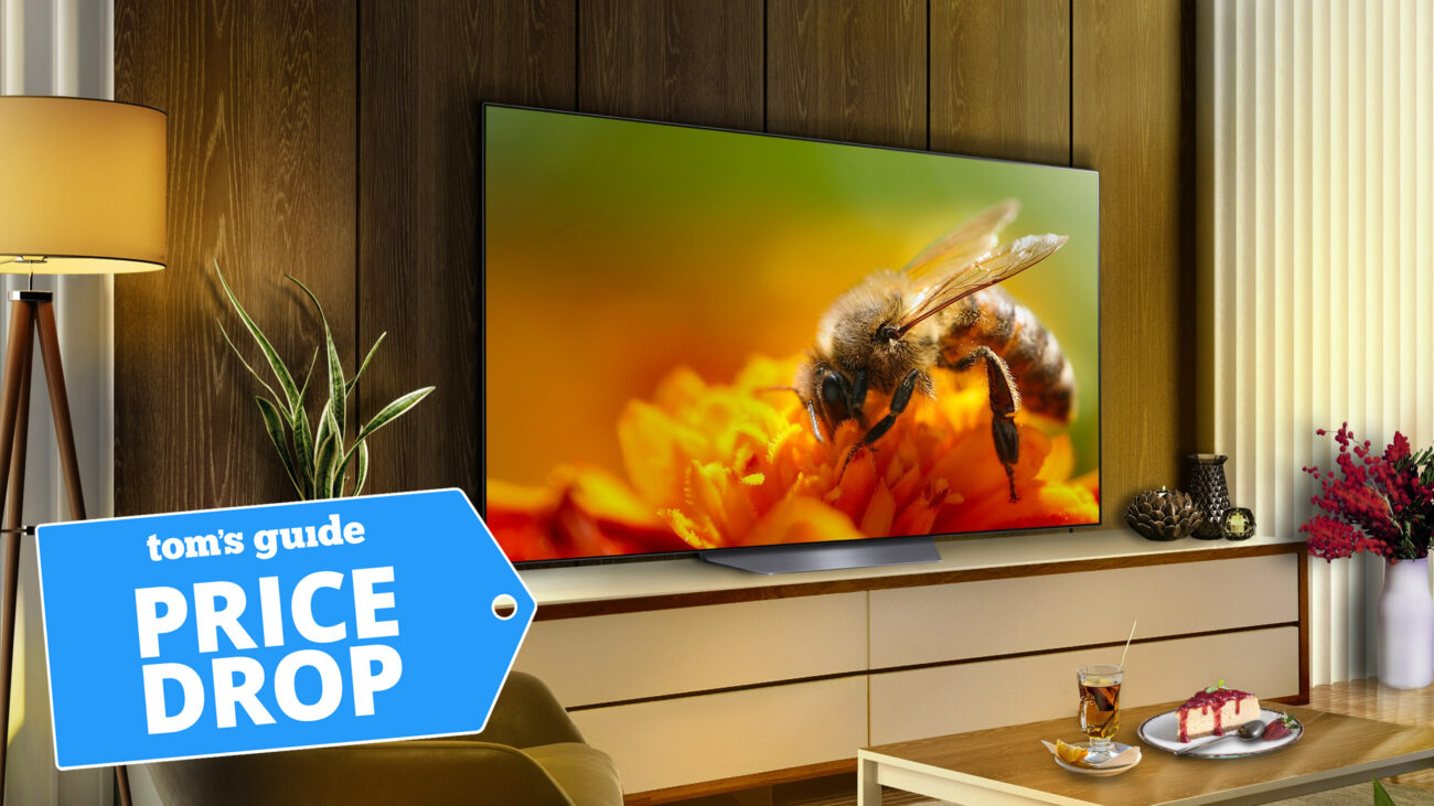 LG B4 OLED lifestyle image showing television on benchtop in living room setting with Price Drop badge overlaid