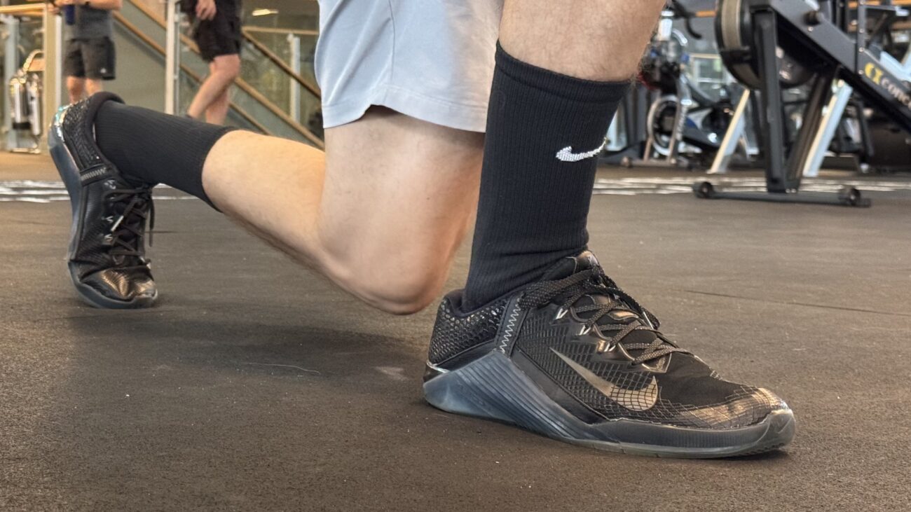 Black Nike shoe worn by man in gym