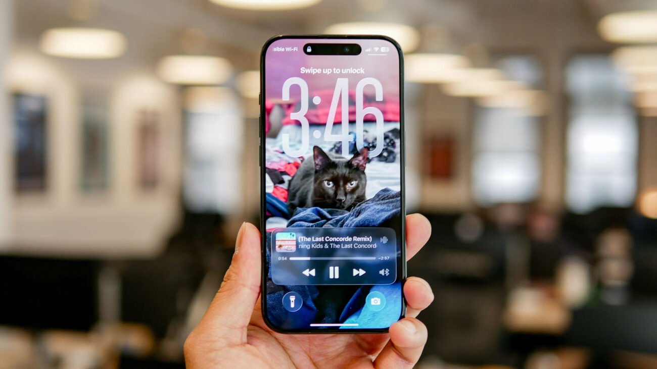 iOS 26 developer beta running on iPhone showing Liquid Glass interface.