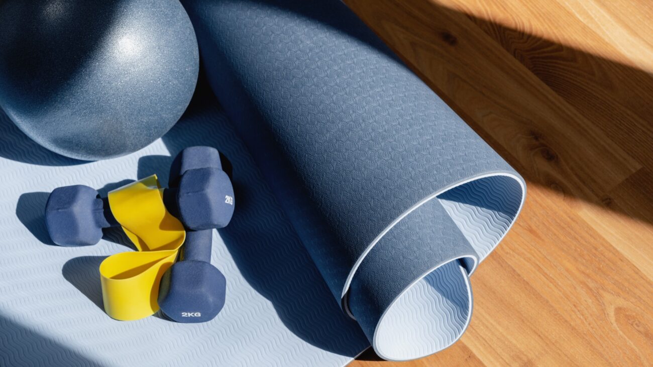 A collection of fitness equipment laid out on a wooden floor