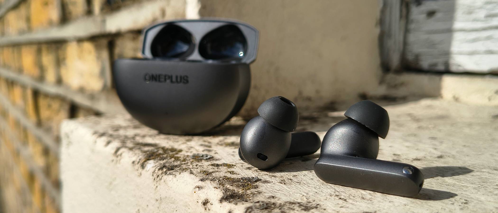 The OnePlus Buds 4 on a window sill.