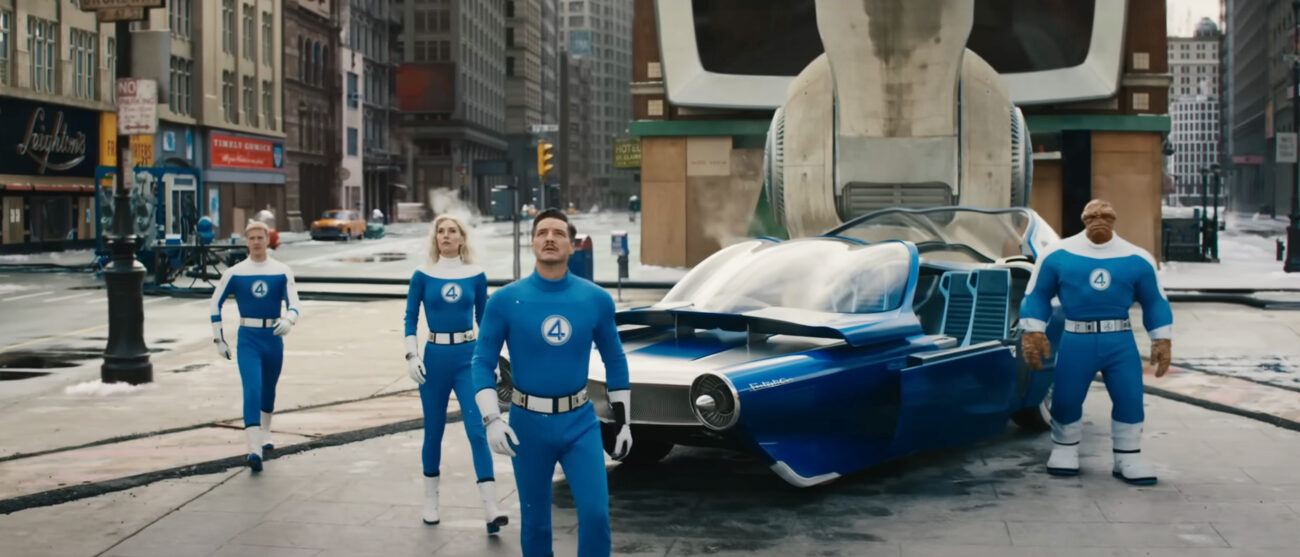 The Fantastic Four standing next to the Fantasticar and looking up in The Fantastic Four: First Steps
