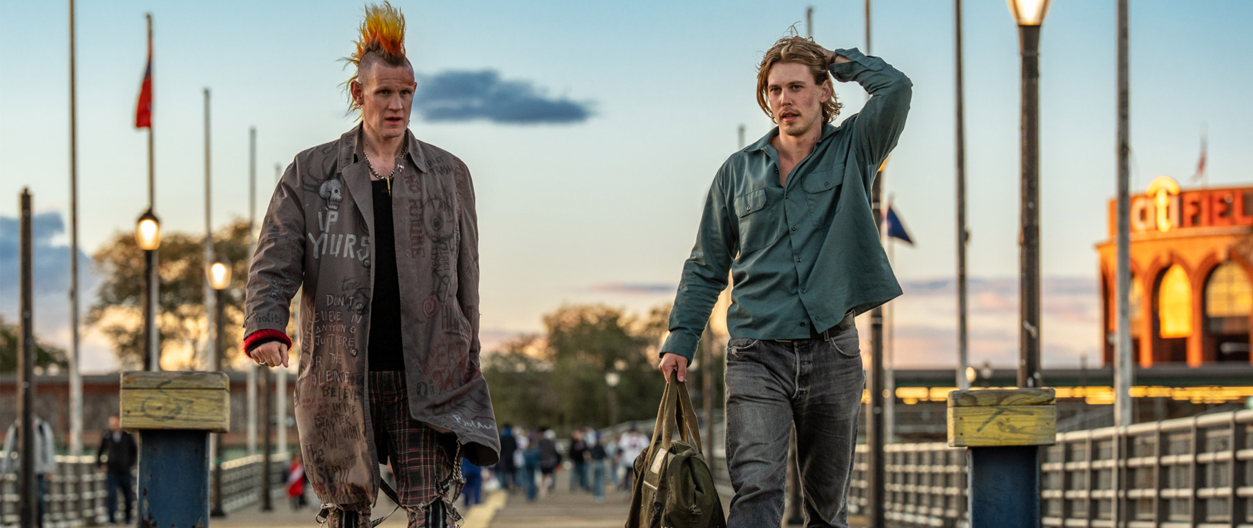 Matt Smith as a punk rocker and Austin Butler walk down a pier