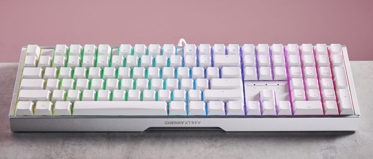 Front of Cherry XTRFY MX 3.1 on desk on with pink background