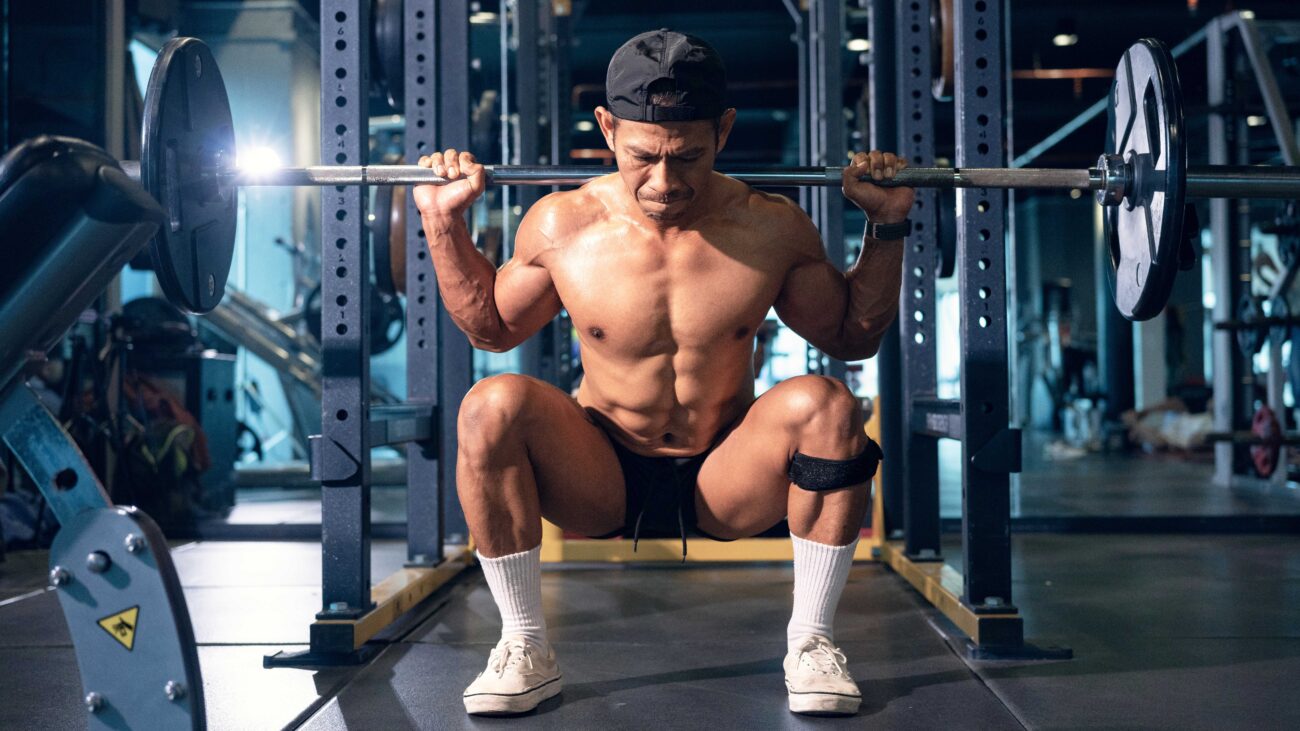 a photo of a man doing a barbell squat