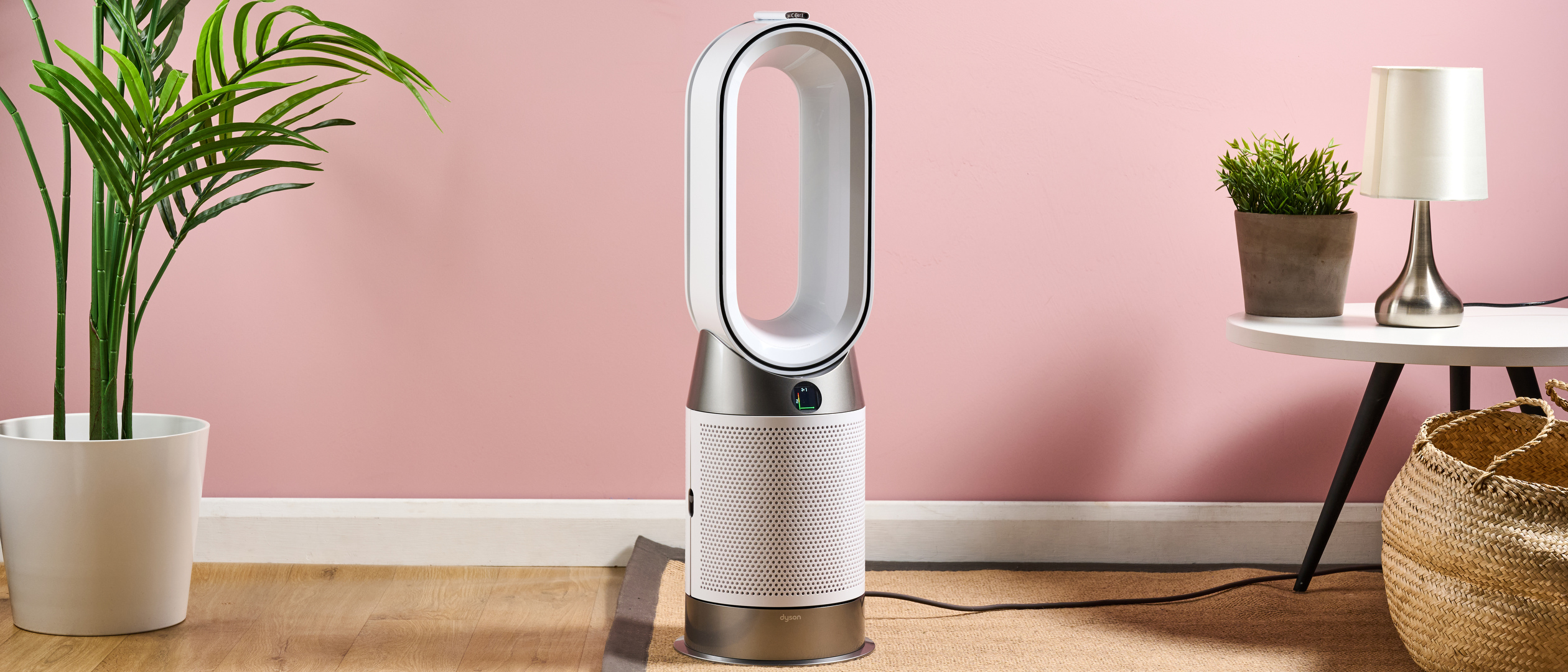 The Dyson HP10 purifying fan heater is pictured in a pink living room.