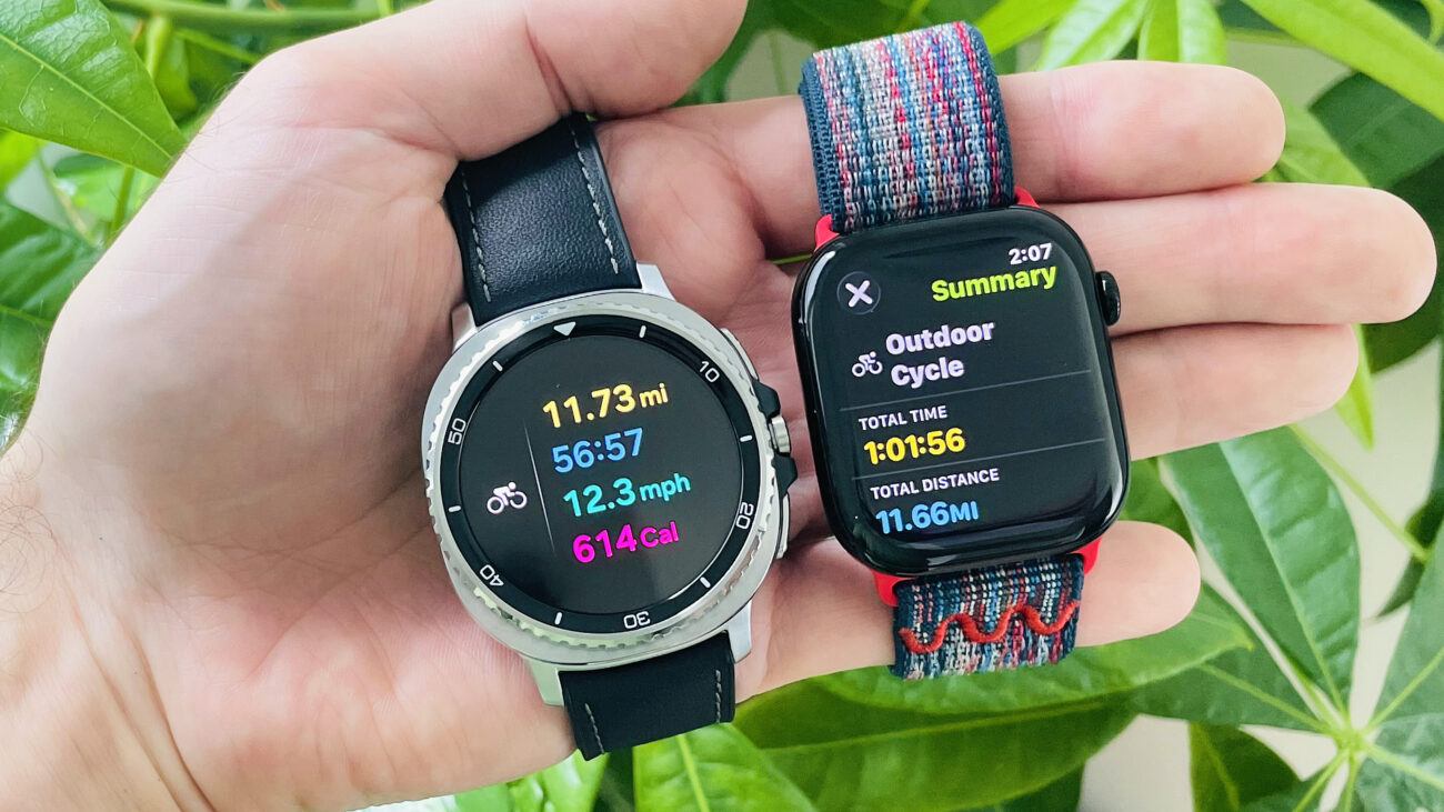 Close-up of the Apple Watch Series 10 and Samsung Galaxy Watch 8 Classic in a user's hand showing the results of a logged bike ride