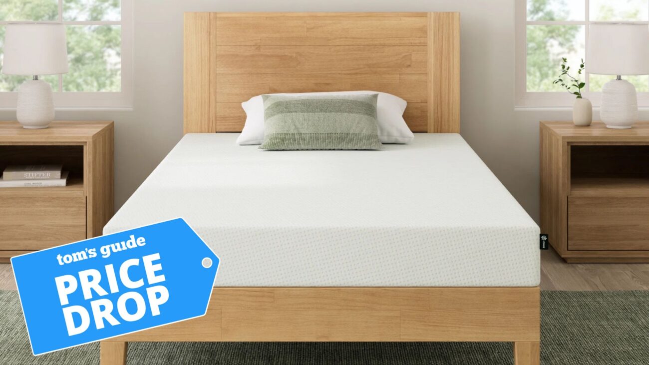 The Zinus Green Tea Memory Foam mattress on a bed frame with a blue Tom's Guide 'price drop' badge on the bottom left