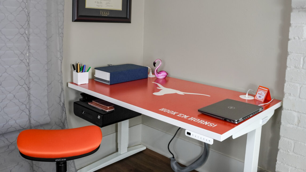 A desk setup built around a University of Texas themed desk from the Uplift Desk Collegiate Collection