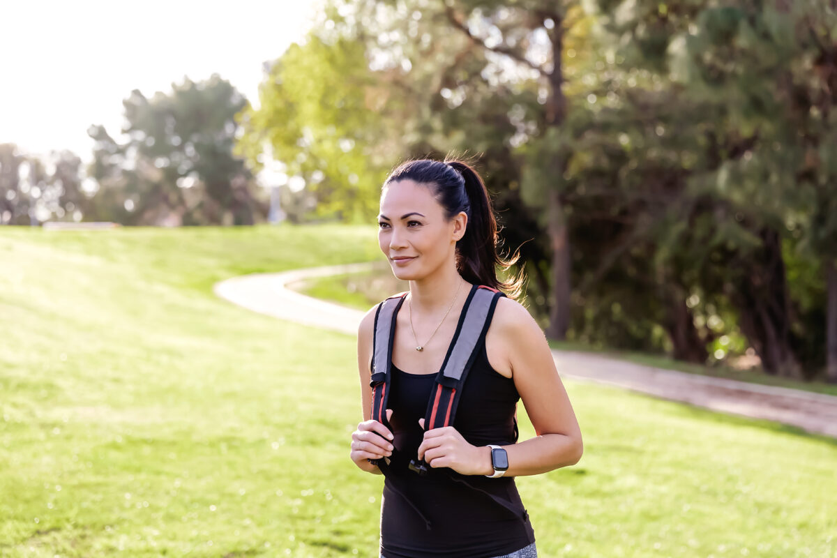 Woman walking outside wearing rucksack