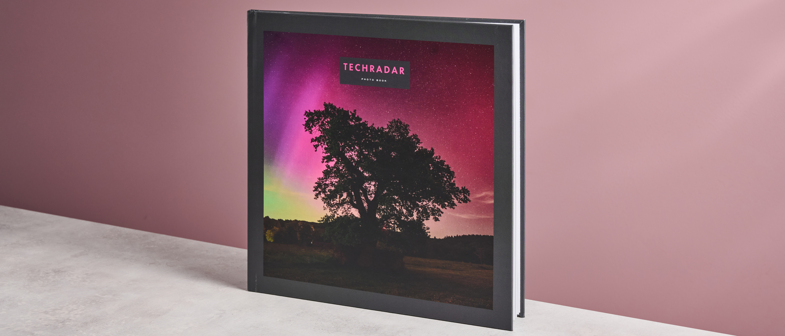 The cover of TechRadar's Papier photo book, featuring a tree in front of an aurora.