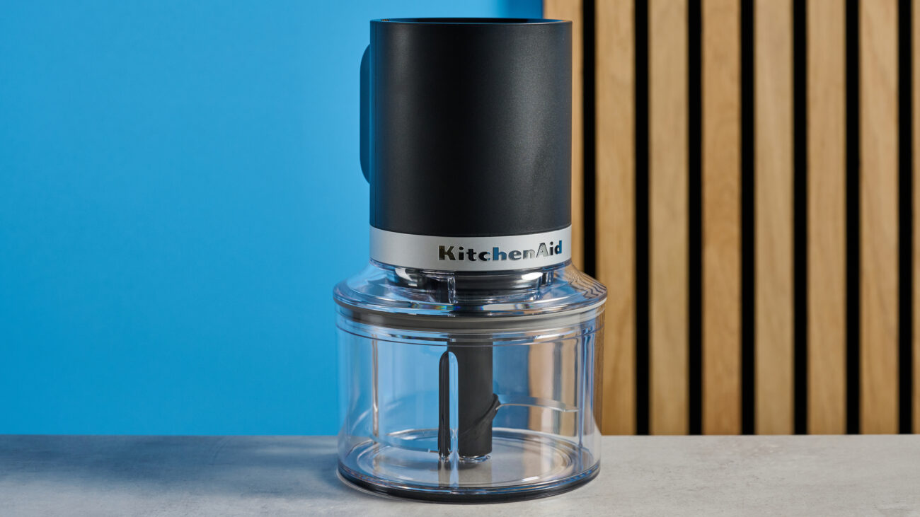 KitchenAid Cordless Top Down Food Chopper photographed in front of a blue background.
