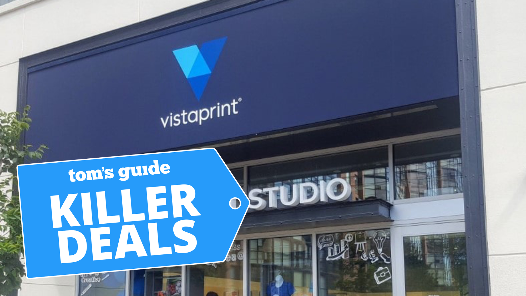 A VistaPrint storefront with a tree outside