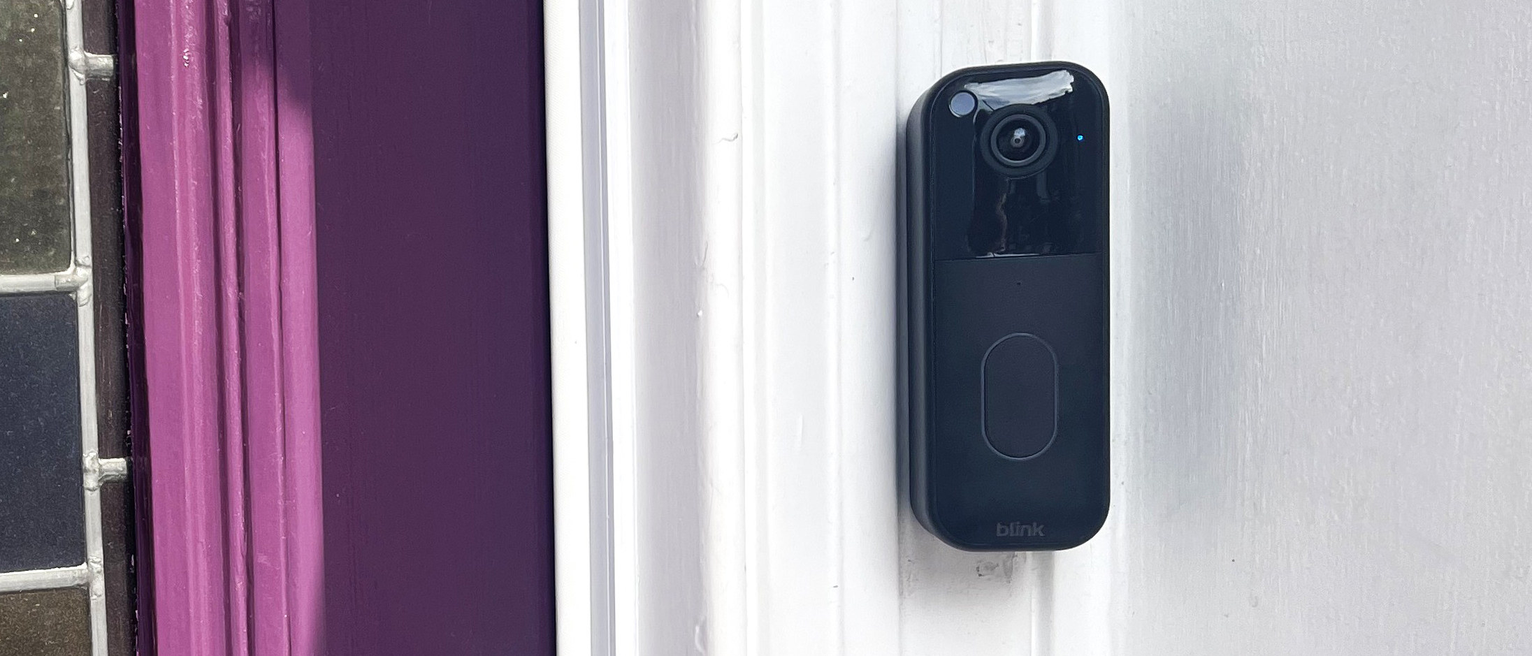 Blink Video Doorbell Gen 2 mounted beside purple door